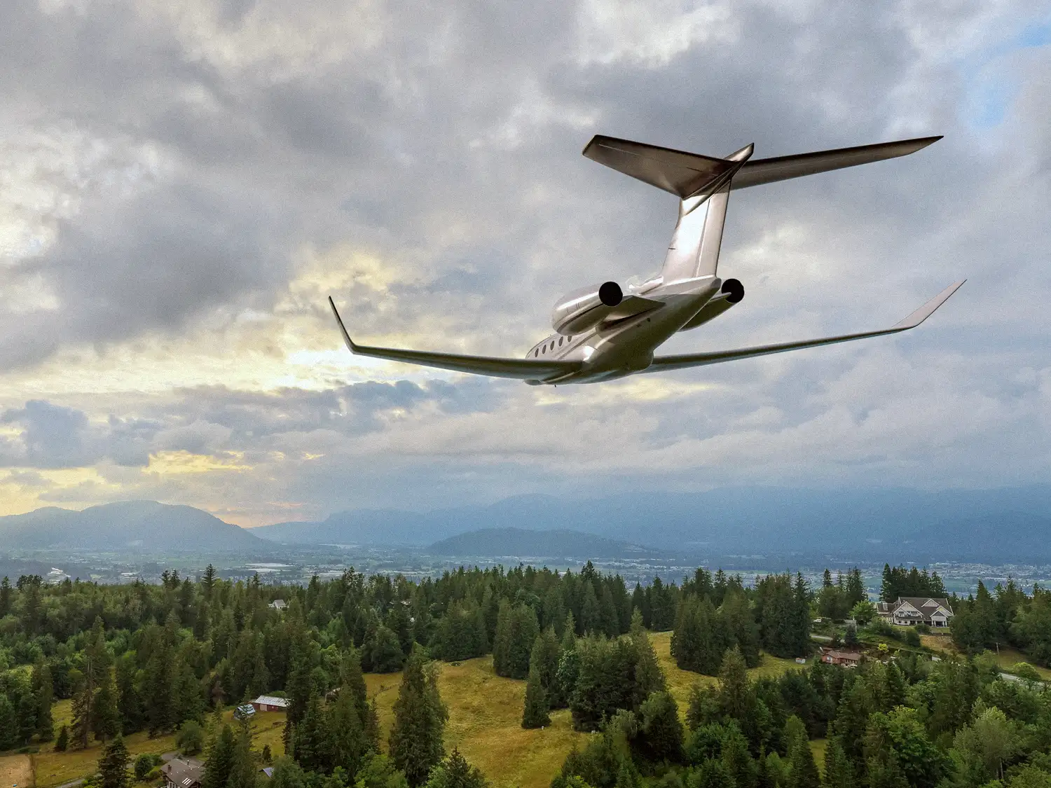 Private jet flying over forested hills and mountains under cloudy skies for private jet charter